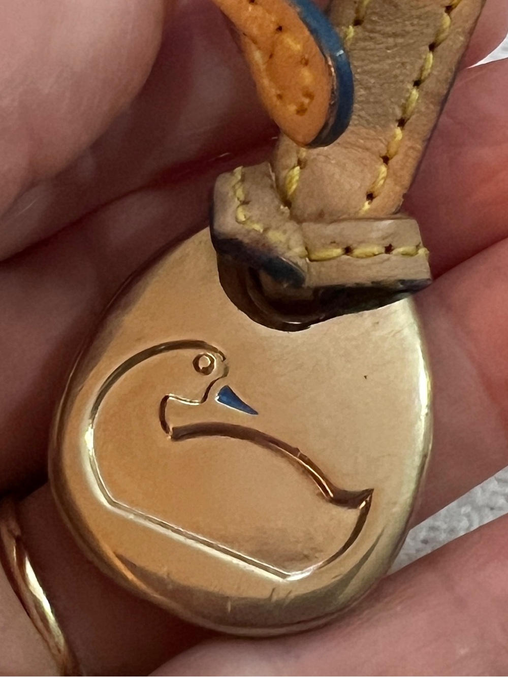 Vintage Dooney & Bourke bag charm fob brass duck logo on a leather strap